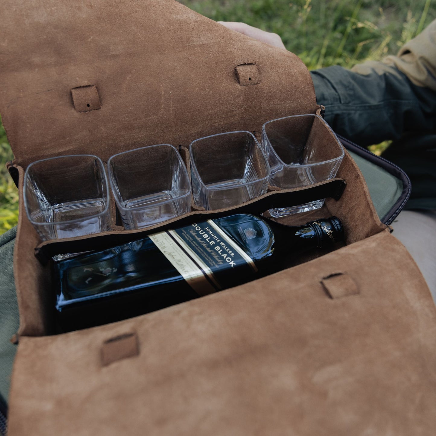 Dark brown leather whiskey bag with johnnie walker whiskey open